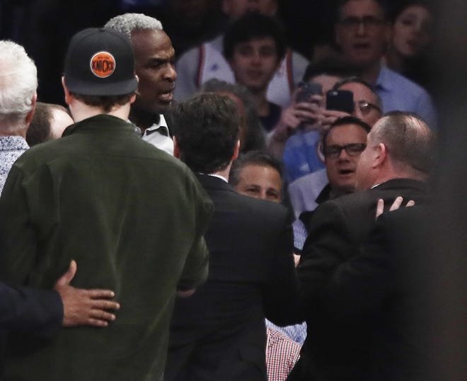 Former Knicks player Charles Oakley exchanges words with a security guard during the first half of the game between the Knicks and Clippers. [THE ASSOCIATED PRESS]