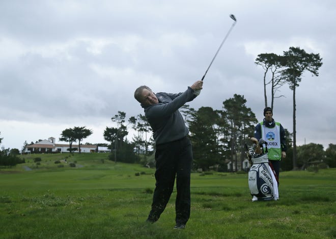 New England Patriots head coach Bill Belichick follows his shot from off the first fairway of the Monterey Peninsula Country Club Shore Course during the first round of the AT&T Pebble Beach National Pro-Am golf tournament Thursday. [ERIC RISBERG / ASSOCIATED PRESS]