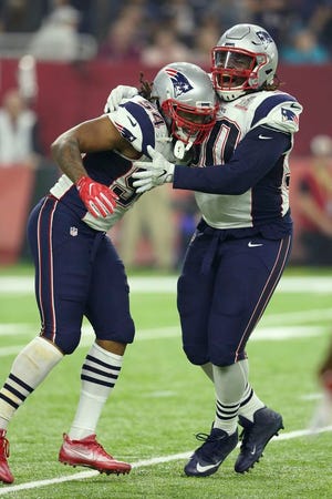 New England Patriots Dont'a Hightower, left, is congratulated by teammate Malcolm Brown after his strip sack of  Atlanta Falcons quarterback Matt Ryan at Super Bowl 51 on Sunday, February 5, 2017 in Houston, Texas.