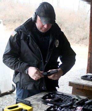 Officer Jesse Grover prepares to test a new Glock at the Painted Post Rod and Gun Club shooting range Wednesday. [SHAWN VARGO/THE LEADER]