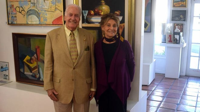 Simon Benson Offit, chairman of the School of the Arts Foundation board, poses with Ellen Liman at her gallery in Palm Beach. Liman will donate all sales proceeds through March 31 to the foundation. Courtesy of Wordsmith Communications