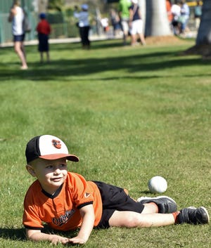Jase Baldwin, 3, of Sarasota shows his sliding form at the Baltimore Orioles SpringFest last year. [HERALD-TRIBUNE ARCHIVE / THOMAS BENDER]