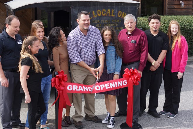 Jamie Parker/Bryan County Now
Local on 17 owner Jay Yancey smiles as he cuts the ribbon marking the grand opening of the restaurant in Richmond Hill Thursday.
