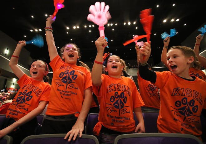 Hundreds of parents, teachers and students took part in the 2017 Are You Smarter than a Gaston County Fifth Grader competition held Thursday night at Stuart W. Cramer High School on Lakewood Road in Cramerton. Here, Kiser Elementary School fifth-graders, from left, Madeline Tyson, Reagan Luckadoo, Brittany Ross and Raleigh Tritell cheer on their team. [MIKE HENSDILL/THE GAZETTE]