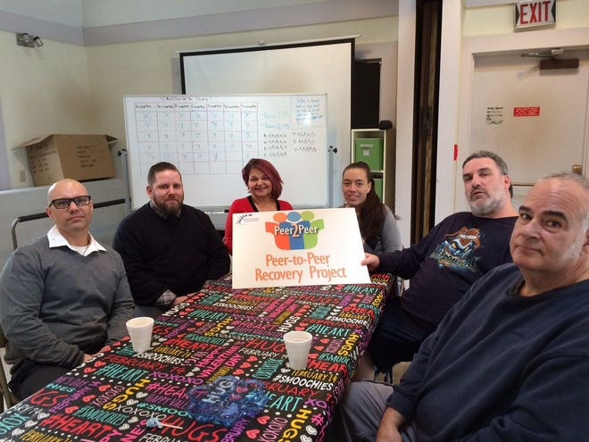 From left, Peer 2 Peer Recovery Project Director Michael Bryant, peer coordinator David Simons, peer specialist Debbie Walker, members Leonora DaPonte and Joe Williamson, and recovery coach Armand Branchaud, talk about their new group.