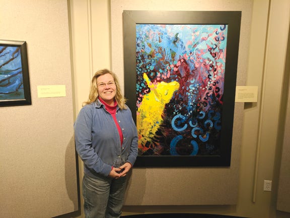 Heidi Reichenbach Finley poses next to one of her more popular pieces, “Llama Looking for Work.” Throughout the month of February Finley’s art will be on display at the Kenneth J. Shouldice Library’s gallery on the campus of Lake Superior State University.