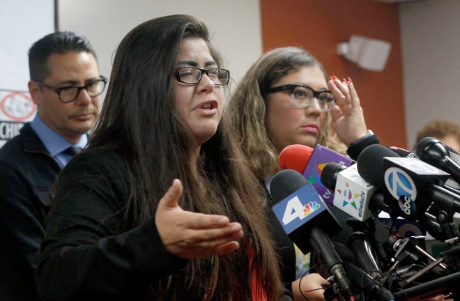 CLARIFIES THAT FATHER HAS NOT BEEN DEPORTED- Marlene Mosqueda, left, who’s father was arrested by ICE agents early Friday morning to be deported, talks at a news conference with her Attorney Karla Navarrette at The Coalition for Humane Immigrant Rights of Los Angeles (CHIRLA) on Friday, Feb. 10, 2017. Navarrete, said she sought to stop Mosqueda from being placed on a bus to Mexico and was told by ICE that things had changed. She said another lawyer filed federal court papers to halt his removal. (AP Photo/Nick Ut)