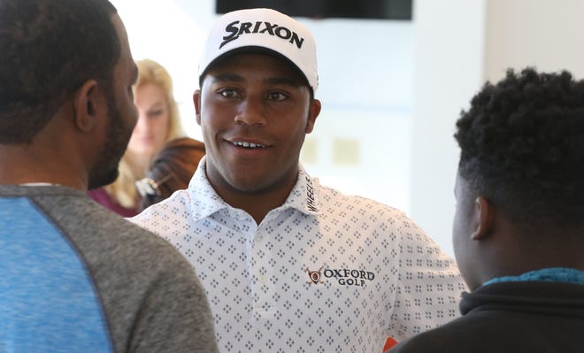 Pro golfer Harold Varner III greeted fans and fellow golfers Saturday at McKenney Chevrolet in Lowell. Here, he talks with two fans from Gastonia. [MIKE HENSDILL/THE GAZETTE]