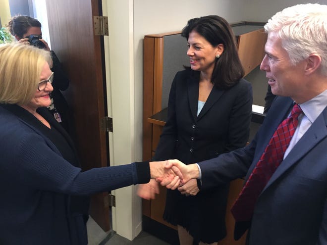 Sen. Claire McCaskill (left) shakes hands with Supreme Court justice nominee Neil Gorsuch as former Sen. Kelly Ayotte (middle) watches. Photo by Adam Aton
