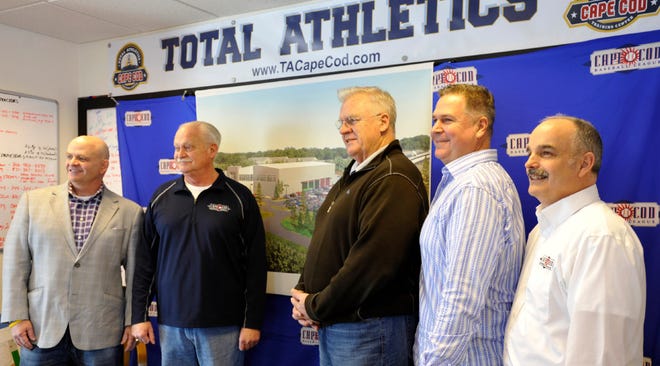 Warren Nighan,left, Chuck Sturtevant, Mike Sherman, Bill Colett and Bill Bussiere pose for a group shot at the Total Athletics Cape Cod offices in Hyannis where they signed an agreement with the Cape Cod Baseball League on Friday.