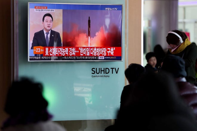 People watch a television screen showing a news broadcast on North Korea's missile launch at Seoul Station in Seoul, South Korea, on Sunday. SeongJoon Cho, Bloomberg