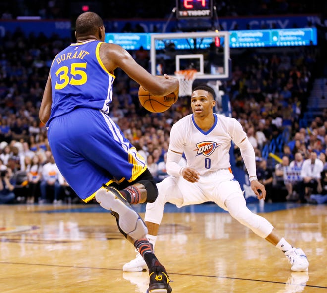Oklahoma City's Russell Westbrook (0) defends Golden State's Kevin Durant (35) during an NBA basketball game between the Oklahoma City Thunder and the Golden State Warriors at Chesapeake Energy Arena in Oklahoma City, Saturday, Feb. 11, 2017. Photo by Nate Billings, The Oklahoman