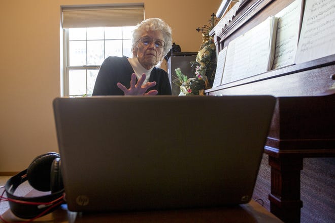 Diann Murdock sets up her laptop before recording herself playing the piano for a recording she is making for her family. "Oh my goodness, I love every aspect of it," she said. "I can go online and look up my health. I do all of my banking on the computer.   [GILLETTE NEWS RECORD / STEEL BROOKS]