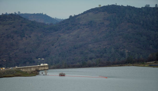 This photo shows the emergency spillway at the Oroville Dam shortly early Monday, Feb. 13, 2017, in Oroville, Calif. Water levels at Lake Oroville are continuing to drop Monday and stopping water from spilling over the spillway. Evacuations for people living below the lake were ordered Sunday after authorities warned the emergency spillway of the Oroville Dam could fail at any time unleashing uncontrolled flood waters on towns below. (AP Photo/Rich Pedroncelli)