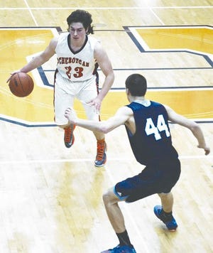 Cheboygan senior guard Mike Radle (23) looks to drive past Petoskey junior forward Jake Lee (44) during the first half of a game in Cheboygan on Monday.