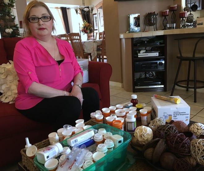 Gloria Osorio sits in front of the dozens of medications that she has taken to control her Lupus, a debillitationg autoimmine disease. [NEWS-JOURNAL/SETH ROBBINS]