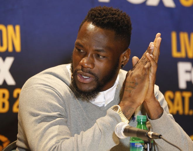 Deontay Wilder addresses the media in Birmingham on Jan. 4. Wilder's surgically repaired right hand is seen as he sits at the press conference table. Staff Photo/Gary Cosby Jr.