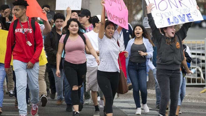 Teenagers gathered at North Lamar Boulevard and Rundberg Lane to protest against ICE on Monday.