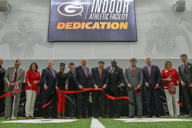 Distinguished members cut the ribbon during a dedication ceremony at the University of Georgia’s new indoor athletic training facility in Athens, Ga., Tuesday, February 14, 2017. The indoor facility will support 21 varsity teams for over 600 student-athletes. The facility, funded by private donors, cost $30.2-million-dollars. (Photo/ John Roark, Athens Banner-Herald)