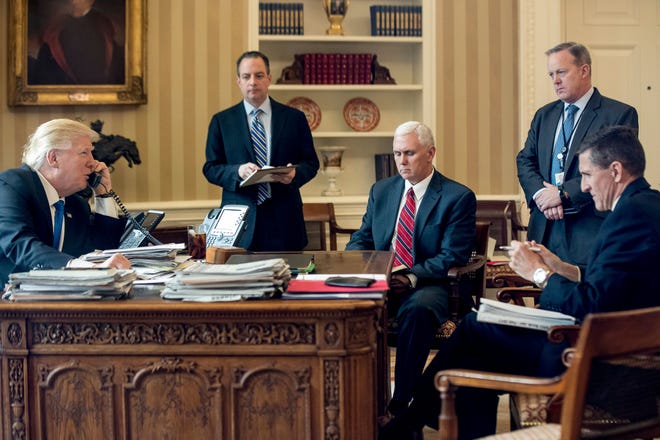 In this Jan. 28, 2017, file photo, President Donald Trump accompanied by, from second from left, Chief of Staff Reince Priebus, Vice President Mike Pence, White House press secretary Sean Spicer and National Security Adviser Michael Flynn speaks on the phone with Russian President Vladimir Putin in the Oval Office at the White House in Washington. Flynn resigned as President Donald Trump’s national security adviser Monday, Feb. 13, 2017. (AP Photo/Andrew Harnik, File)