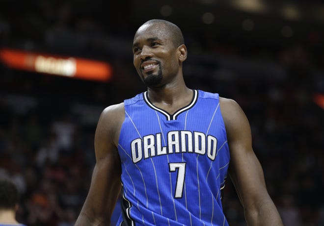 Orlando Magic's Serge Ibaka (7) smiles after being called for a foul against Miami Heat's Goran Dragic (7) during the second half of a game Monday in Miami. The Magic traded Ibaka to Toronto on Tuesday. [AP Photo/Lynne Sladky]