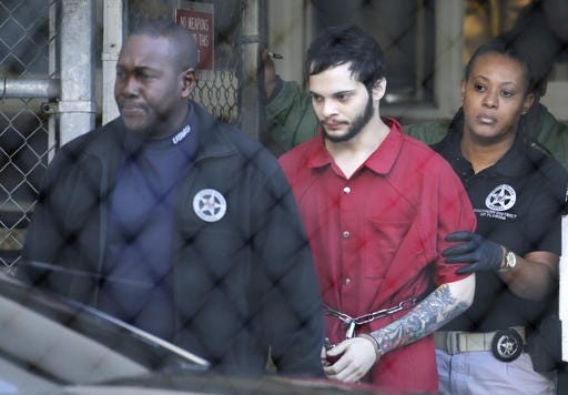 FILE- In this Jan. 30, 2017, file photo, Esteban Santiago, center, is led from the Broward County jail for an arraignment in federal court in Fort Lauderdale, Fla. Santiago, who is accused of killing five people at a Florida airport, lied about his criminal record on his application to be a security guard in Alaska, and was fired after only a few months on the job because of the state of his mental health. The state released the application Monday, Feb. 13, to The Associated Press, which had appealed the state's initial refusal to release the document made through an open records request. (AP Photo/Lynne Sladky, File)