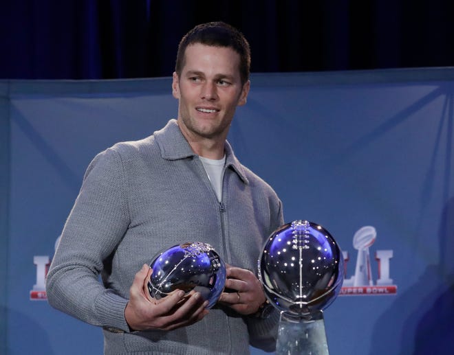 FILE - In this Feb. 6, 2017, file photo, New England Patriots quarterback Tom Brady walks off with his MVP trophy during a news conference after the NFL Super Bowl 51 football game in Houston. Zoo Atlanta announced Monday, Feb. 13, 2017, that it named a baby cockroach after Brady. (AP Photo/Morry Gash, File)