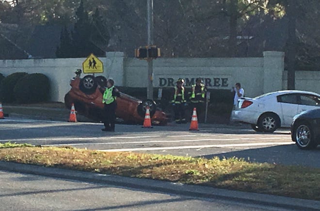 A two-vehicle collision that left a car overturned is causing delays on Independence Boulevard at Canterbury Road. [ASHLEY MORRIS/STARNEWS]
