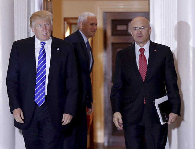 In this Nov. 19, 2016 file photo, then-President-elect Donald Trump walks Labor Secretary-designate Andy Puzder from Trump National Golf Club Bedminster clubhouse in Bedminster, N.J. Puzder withdrew his nomination on Wednesday after Republicans said they were concerned over his failure to pay taxes for five years on a former housekeeper who wasn’t authorized to work in the U.S.