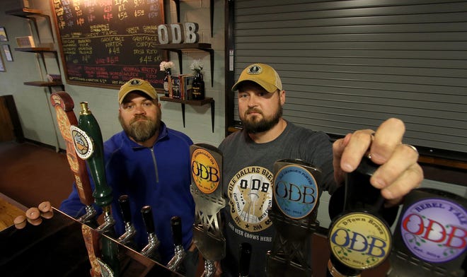 Ole Dallas Brewery taproom is now open. Here, (L-R) Beau Norwood and Chris Cloninger pose at the taps inside the brewery on Durkee Lane in Dallas Monday afternoon. [MIKE HENSDILL/THE GAZETTE]