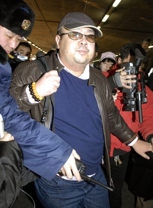 In this Feb. 11, 2007, file photo, a man believed to be Kim Jong Nam, is surrounded by the media upon arrival from Macau at Beijing airport in Beijing. THE ASSOCIATED PRESS