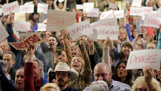 Protesters react at a town hall meeting sponsored by U.S. Rep. Jason Chaffetz, R-Utah