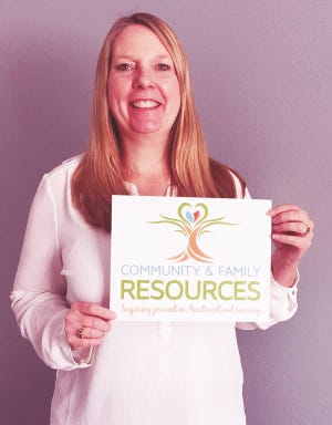 Community and Family Resources Executive Director Michelle De La Riva displays CFR’s new logo. The Iowa nonprofit provider of behavioral health services is launching its first re-brand in nearly 20 years.