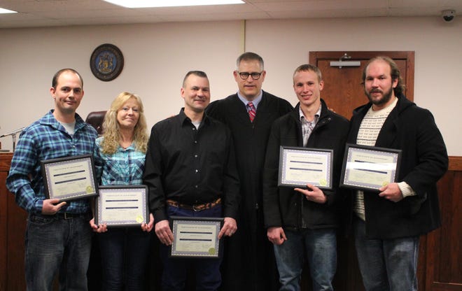 Six participants graduated from Ionia Treatment and Sobriety Court Thursday morning in Ionia County 64-A District Court. From left, Bill Ferrier, Laureen Cook, Don Cousins, Judge Raymond Voet, Adam Schafer and Eric Proctor. Not Pictured is Floyd Richards. [DARCY MEADE/IONIA SENTINEL-STANDARD]