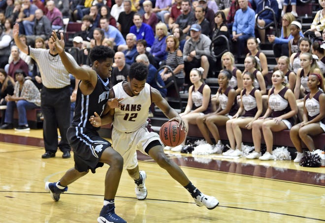 The Riverview Rams' Brion Whitley (12) gets called for traveling against Orlando's Dr. Phillips during the boys Class 9A-Region 2 quarterfinal at Riverview High on Thursday evening. [HERALD-TRIBUNE STAFF PHOTO / THOMAS BENDER]