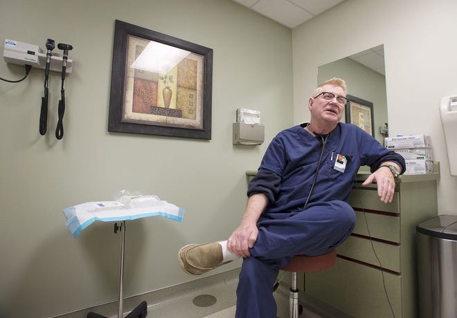 Dr. Bernie Geiser talks about the increase in flu cases he's seen at MedExpress Urgent Care during the last month on Thursday afternoon in Chippewa Township.