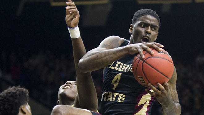 Florida State’s Dwayne Bacon (4) grabs a rebound over Notre Dame’s T.J. Gibbs (2) during the first half of their game last Saturday in South Bend, Ind. (AP Photo/Robert Franklin)