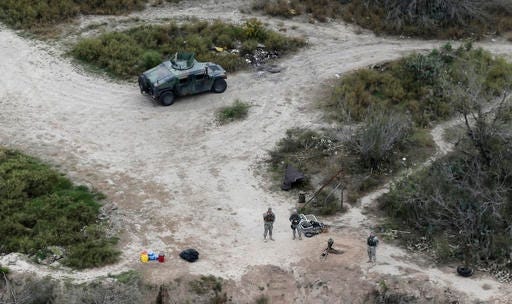 In this Feb. 24, 2015, file photo, members of the National Guard patrol along the Rio Grande at the Texas-Mexico border in Rio Grande City, Texas. The Trump administration is considering a proposal to mobilize as many as 100,000 National Guard troops to round up unauthorized immigrants, including millions living nowhere near the Mexico border, according to a draft memo obtained by The Associated Press.