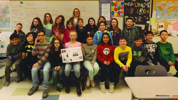 Students in Grade 4G at the Leroy Wood School in Fairhaven show off the newspaper they printed last week. They are: front row (seated) from left to right, CJ Coelho, Ben Comey, Logan DaCosta, Makayla Walsh, Kalli Pimental, Avery Santos, Giselle Souza, Logan Hart-Bonville, Boston Bettencourt, Braylon Arruda, and Zachary Viveiros. Second row (standing) from left to right, Dominic Haskell, Carly Bradshaw, Maya Lussier, Lily Mills, Vera Carle-Ericson, Elle McCormick, Alison DaSilva, Aidan Nelson, Kendra Lima, Ainsley Cebula, and Christopher Barney. Mrs. Kelly Guilfoyle is standing against the back wall.