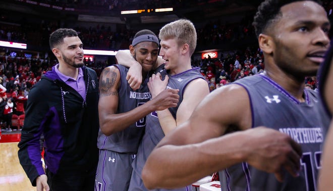 Northwestern's Dererk Pardon, second from left, and Nathan Taphorn celebrate Northwestern's 66-59 win over Wisconsin in an NCAA college basketball game Sunday, Feb. 12, 2017, in Madison, Wis. (AP Photo/Andy Manis)