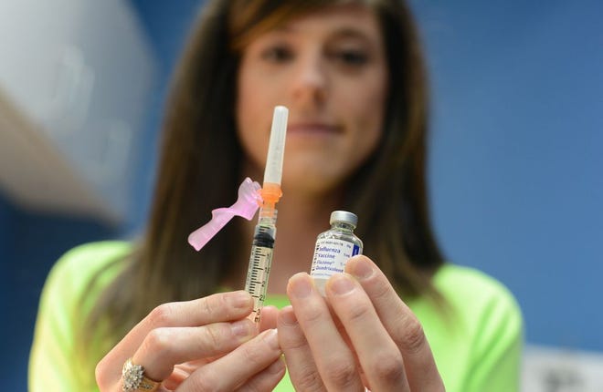 Amanda Poole, RN, prepares the flu vaccine Thursday at Kinston Pediatrics on Queen Street.