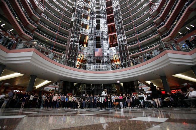 In this March 19, 2013 file photo, soprano Renee Fleming performs with world-famous cellist Yo-Yo Ma and a choir of dozens of high school students in the rotunda of the James R. Thompson Center in Chicago. (AP Photo/Kiichiro Sato, File)