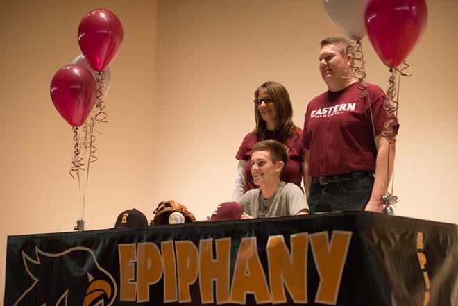 Epiphany senior Jeffrey Williams signs his National Letter of Intent to play baseball in college at Eastern University. He is joined here by his father Daniel and mother Donna.