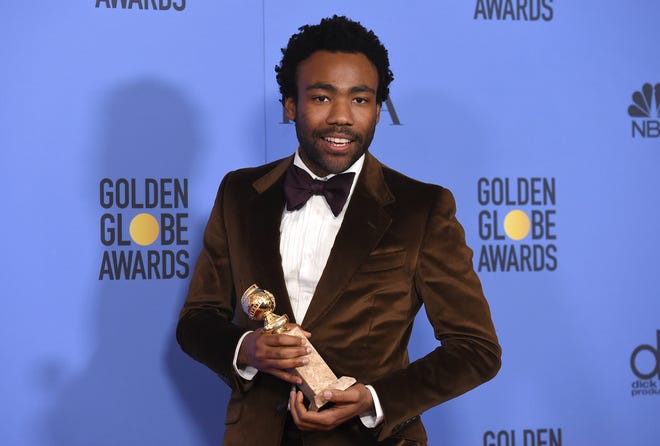 FILE - In this Jan. 8, 2017 file photoi, Donald Glover poses in the press room with the award for best performance by an actor in a television series - musical or comedy for “Atlanta” at the 74th annual Golden Globe Awards at the Beverly Hilton Hotel in Beverly Hills, Calif. Glover and James Earl Jones are lending their voices to Disney’s upcoming remake of “The Lion King.” Director Jon Favreau announced Friday, Feb. 17, 2017, the casting of the two men as voice actors. Glover, star and creator of television’s “Atlanta,” will portray the adult Simba. Jones reprises the role of Simba’s father, Mufasa, which he voiced in the 1994 animated film. (Photo by Jordan Strauss/Invision/AP)
