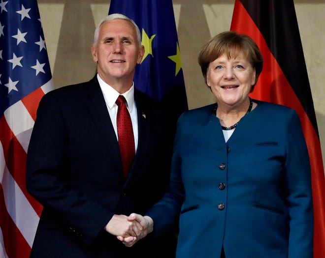 United States Vice President Mike Pence, left, and German Chancellor Angela Merkel meet for bilateral talks during the Munich Security Conference in Munich, Germany, Saturday, Feb. 18, 2017. The annual weekend gathering is known for providing an open and informal platform to meet in close quarters. (AP Photo/Matthias Schrader)