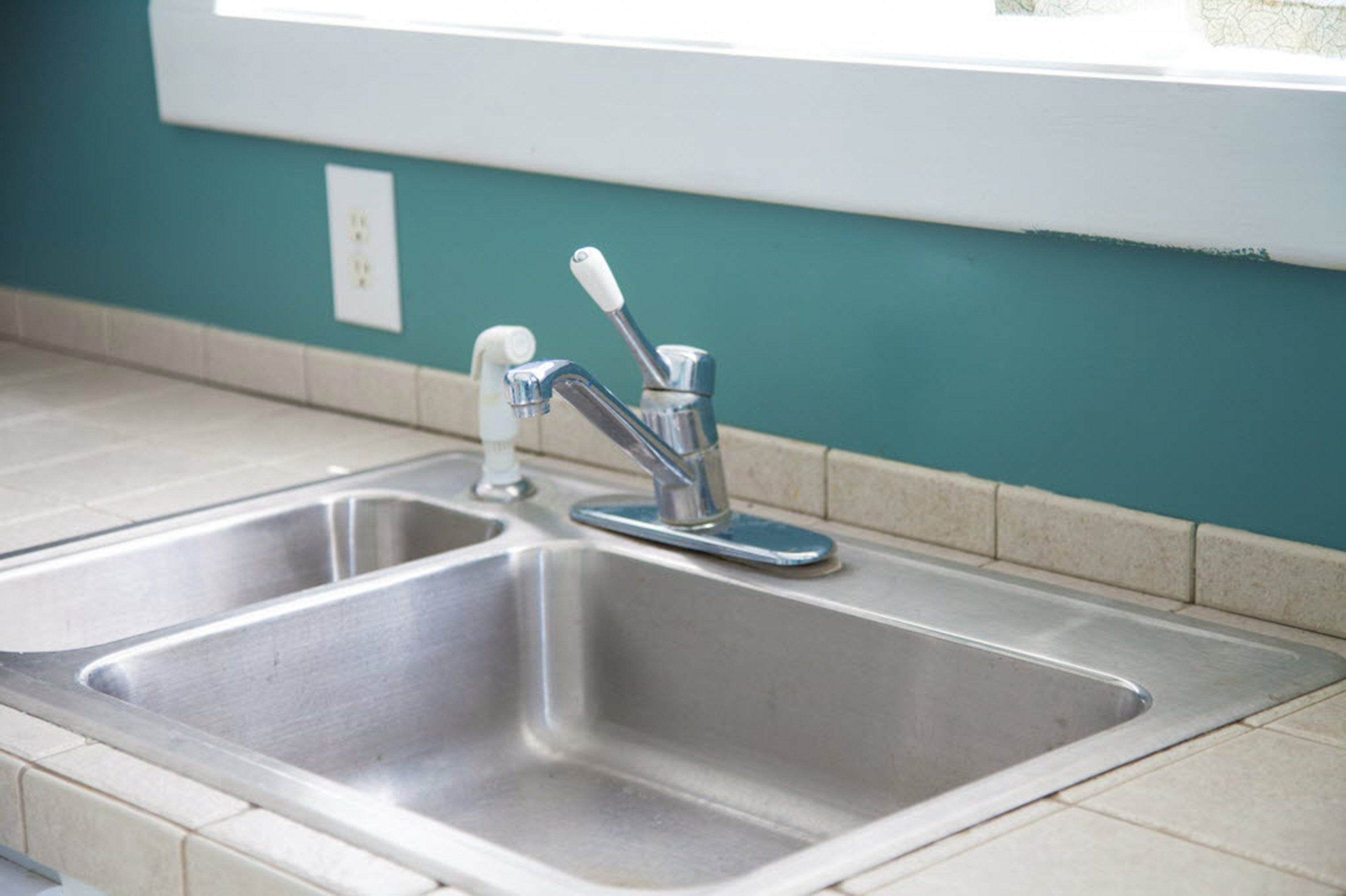 Why is water leaking under my kitchen sink?
