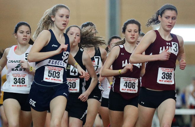 Runners are packed tight near the beginning of the 3000 meter race at the state indoor track championships on Saturday.