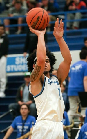Springfield's Nicolas AhSam makes three of his 25 points during the Miller's and Lancer's Midwestern League meeting on Friday in Springfield. (Collin Andrew/The Register-Guard)