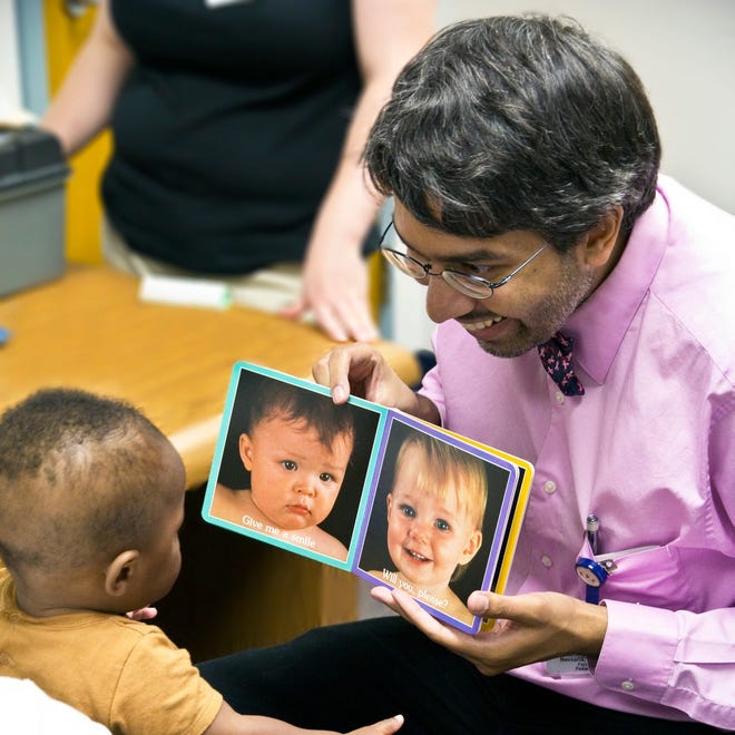 Dr. Dipesh Navsaria is pictured with a young patient. [COURTESY PHOTO / PARKER HOERZ]