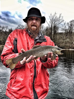 Nathan “Shags” McLeod, the host of the “Morning Shag” on Columbia’s 96.7 FM, shows off a trout he caught at Lake Taneycomo.